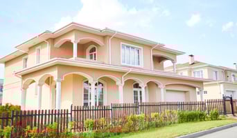 Wide angle shot beautiful two story house in Florida neighborhood, view from road