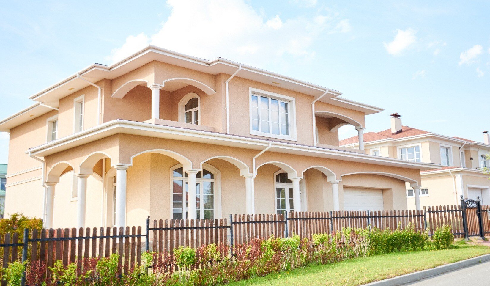 Wide angle shot beautiful two story house in Florida neighborhood, view from road