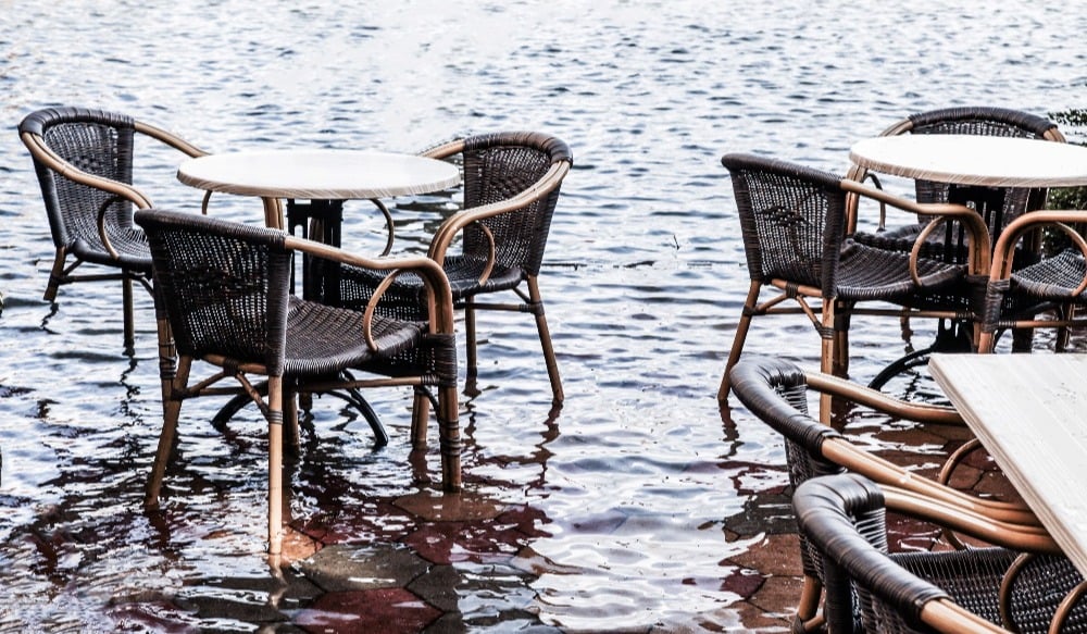 Cafe flooded with water - table and chairs in water