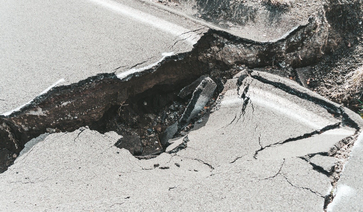 Crack in the road tarmac caused by sink hole