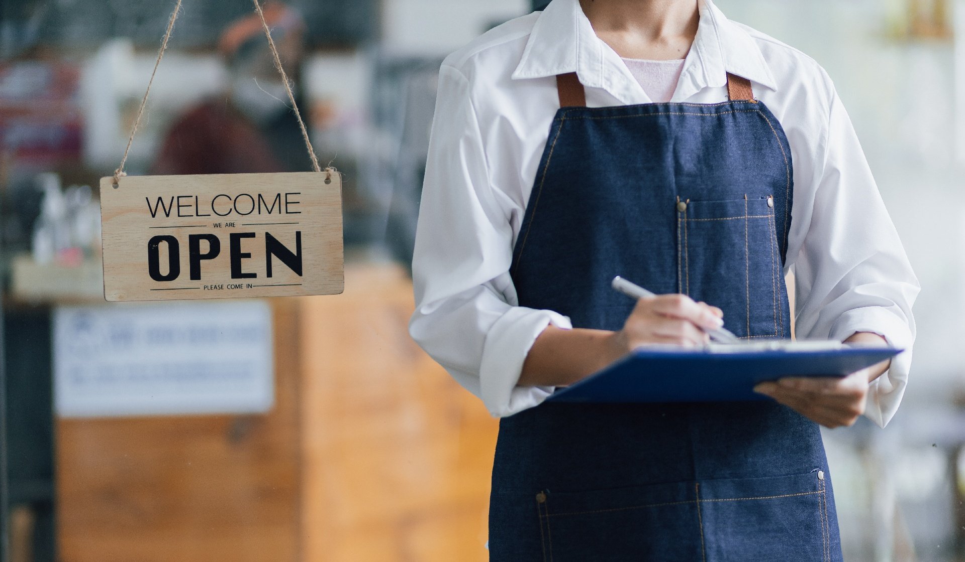 Person taking notes at an open business